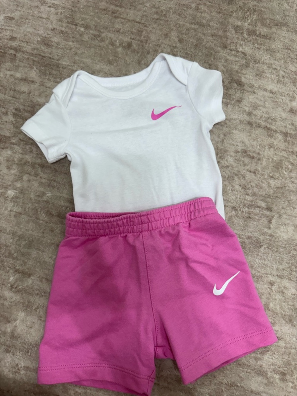 Nike White Baby Bodysuit with Pink Swoosh